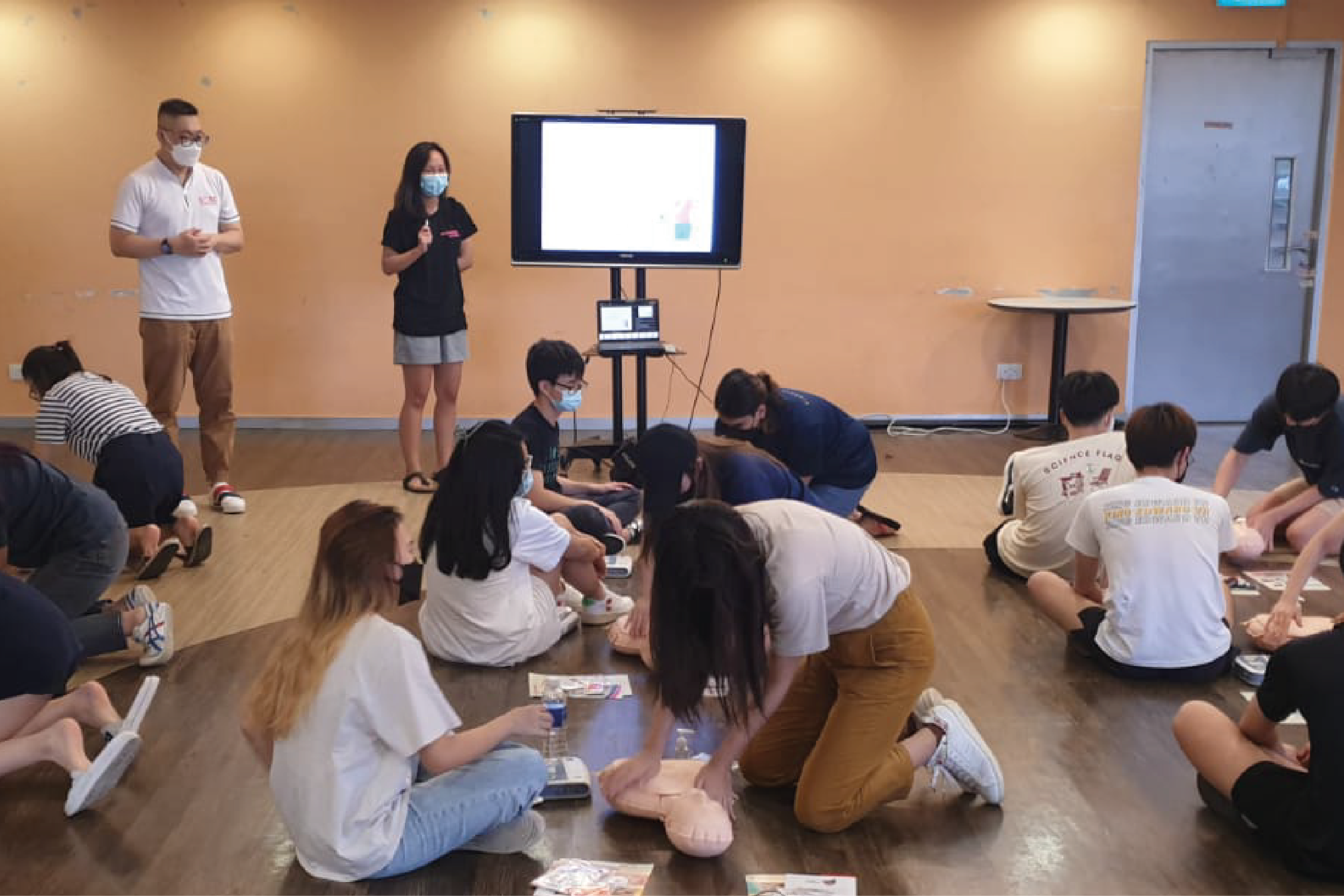 Photo of a learner practicing facilitation of the DARE programme under the guidance of a DARE trainer.